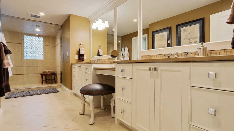 Custom vanity cabinets in a modern luxury bathroom featuring a large walk-in shower