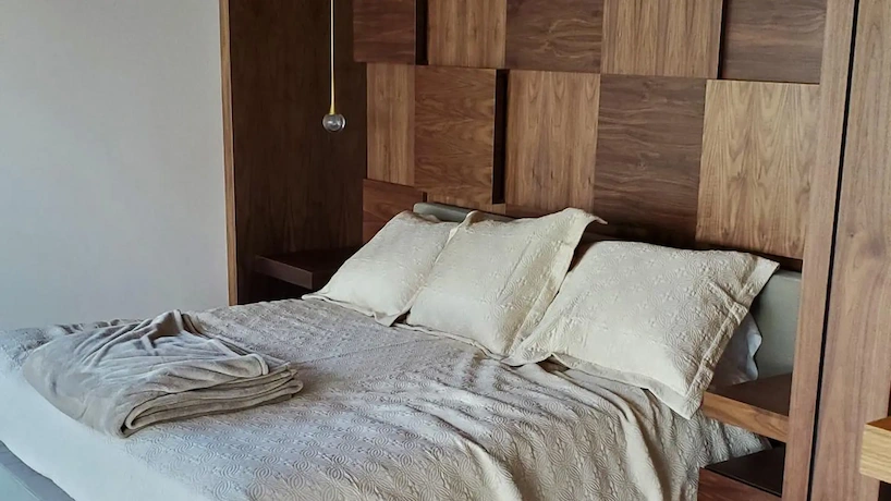 Bedroom with custom woodwork headboard