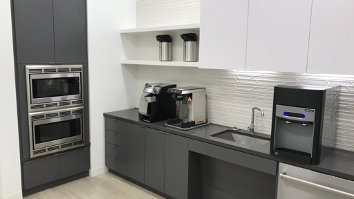 a kitchen with stainless steel appliances and a coffee maker