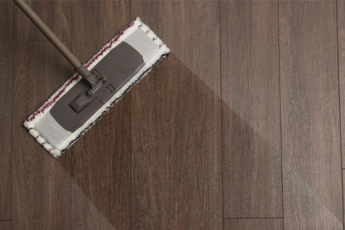 A picture of a mop and a clean path on the floor