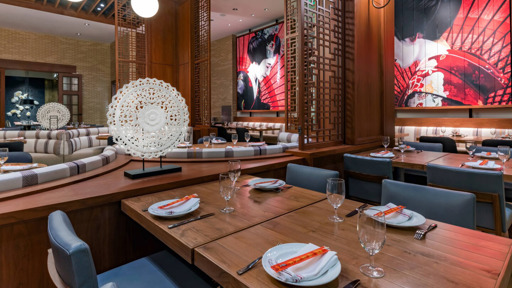 a restaurant  with blue chairs and plates on table