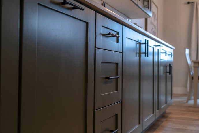 Close-up of cabinets in dark wood with modern hardware