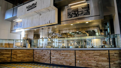 a restaurant with glass food counter