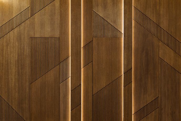 Hidden door installation and wooden panel in modern interior design of the reception of the house.