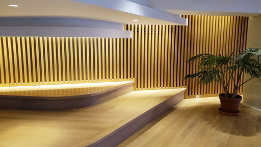 a room with wooden slats and a potted plant