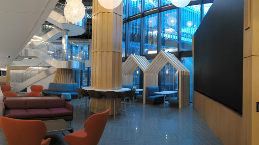 a lobby with couches and chairs in a modern building
