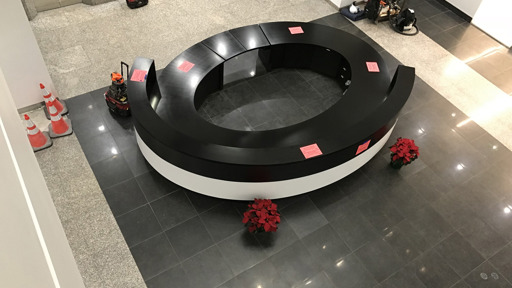 a black and white reception desk in an office building