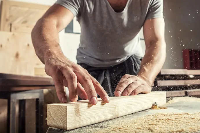 woodworker working on a piece of trim