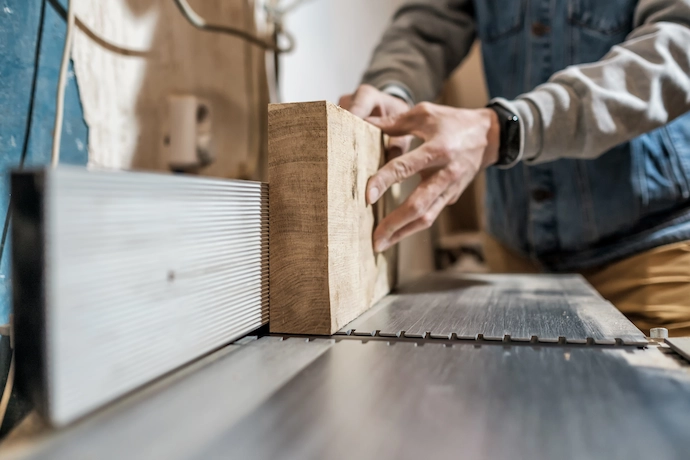 Man making custom wooden part for custom cabinets