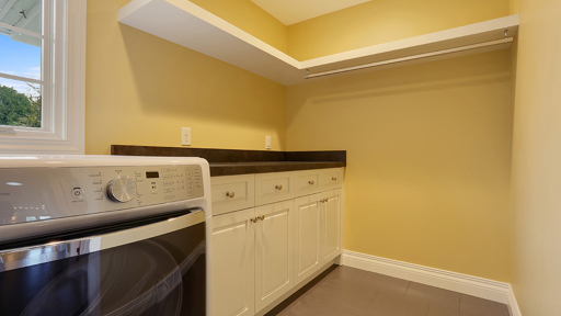 a yellow laundry room with washing machine
