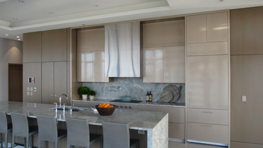 a modern kitchen with a center island and bar stools