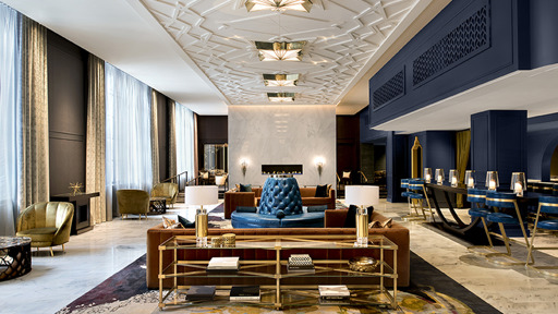 the lobby of a hotel is decorated in blue and gold