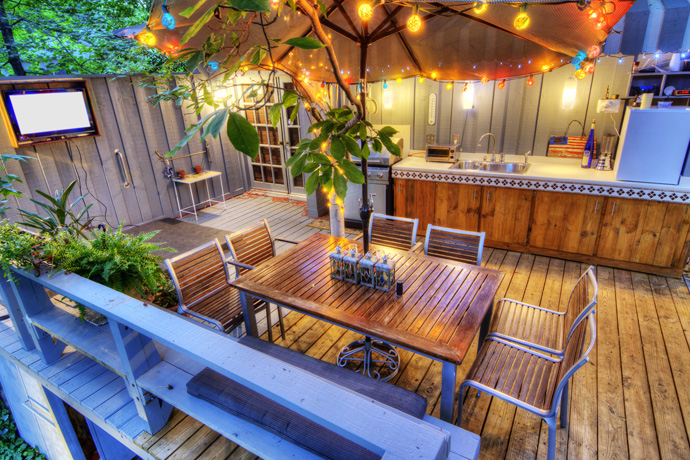 Outdoor living space with kitchen and lights