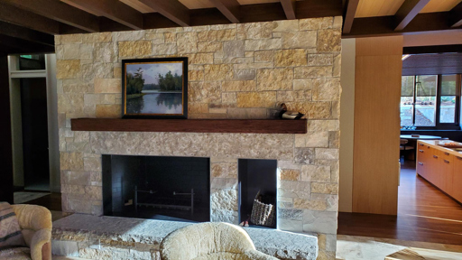 a stone fireplace in a living room