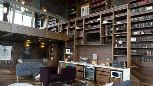 a living room with bookshelves and a fireplace