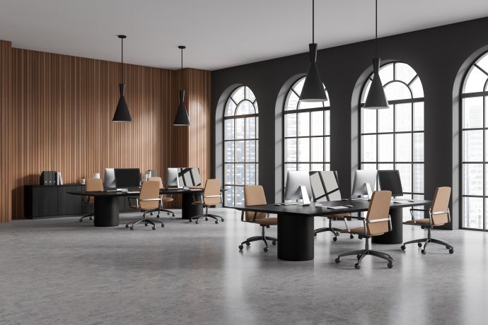 Open-concept office space with workstations and tall windows