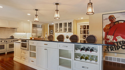 a kitchen with a large island and a wine rack