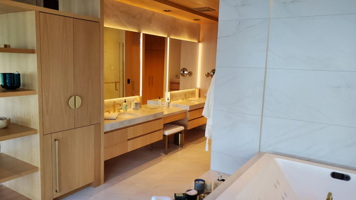 a bathroom with a bathtub, sink and mirror