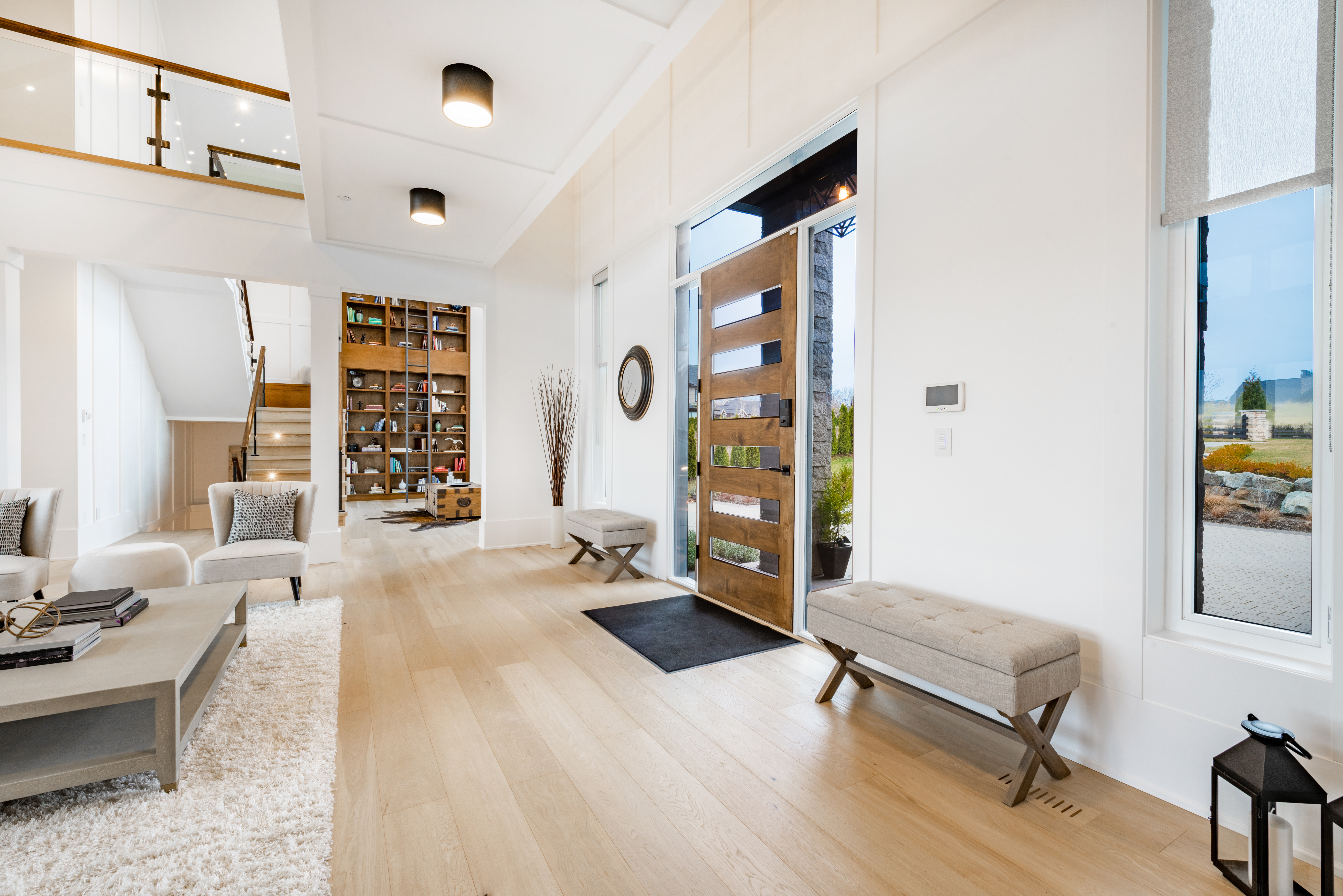 Modern home entryway with wood flooring and custom front door