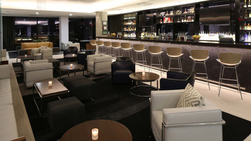 a lounge area with chairs and a bar