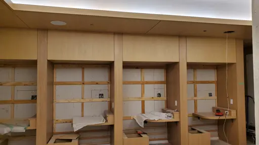 a room that is being remodeled with wooden cabinets and desks