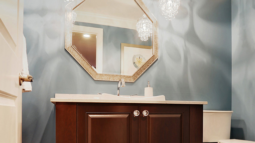 a bathroom with a sink, mirror, and toilet