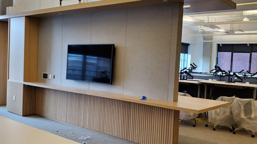 an office with a tv mounted on the wall