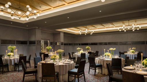 a banquet room set up with tables and chairs