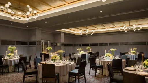 a banquet room set up with tables and chairs